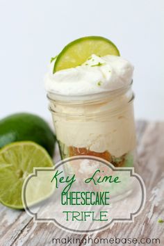 key lime cheesecake trifle in a mason jar with two limes on the side