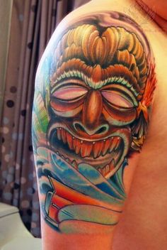 a man with a tattoo on his arm has a colorful mask and is holding a knife