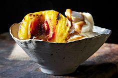 a bowl filled with ice cream and fruit