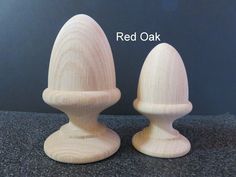 two wooden salt and pepper shakers sitting side by side on a black countertop