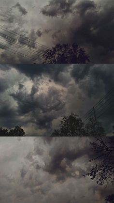 the sky is filled with dark clouds and trees