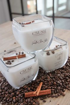 three candles sitting on top of coffee beans