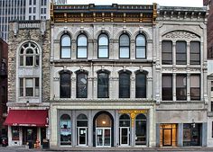 an old building with many windows on the corner