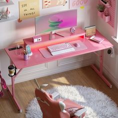 a pink desk with a computer on it