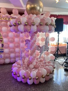 balloons are arranged in the shape of animals and unicorns for a balloon arch at a birthday party