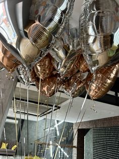 many shiny balloons are hanging from the ceiling