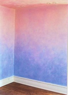 an empty room with blue and pink walls