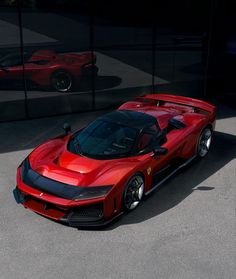 a red sports car parked in front of a building