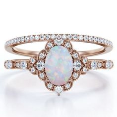 a white opal and diamond ring set in rose gold with diamonds on the band