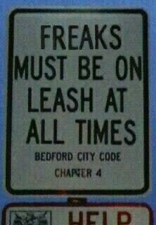 a sign that says freaks must be on leash at all times bedford city code changer 4