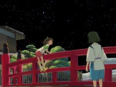 two people standing on a red bridge looking at the stars in the sky above them