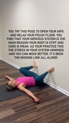 a woman laying on the floor in front of a wall with words written on it