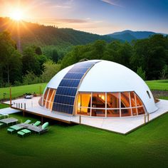 a large white dome house sitting on top of a lush green field next to a forest