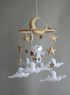 a mobile with stars, moon and an elephant hanging from it's side in the sky