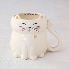 a white ceramic cat mug with the words i love cats on it's face