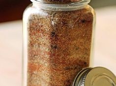 a jar filled with brown stuff sitting on top of a table