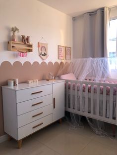 a baby's room is decorated in pink and white