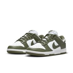 The Nike Women's Dunk Low 'Medium Olive' is the perfect blend of archival hoops style and contemporary design. Showcasing a classic two-tone color scheme, these comfortable sneakers feature a crisp white base with olive green overlays for added depth. The Nike Swoosh further accents the design in color-matched detail. Underpinned by a traditional rubber cupsole, the cushioning foam wedge provides superior comfort and impact protection, while the olive outsole ensures reliable traction when on the court. This updated version of the iconic Be True to Your School series from 1985 delivers timeless appeal with modern performance tech that make sure you stand out in style and comfort. Nike Dunk Low Medium Olive, Dunk Lows, Kitty Pictures, Sneaker Trend, Nike Model, Nike Models, Adidas Spezial, Baskets Nike, Sports Trainers