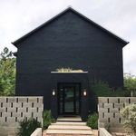 a black house with steps leading up to it