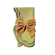 a green napkin with a bow on the front and brown ribbon at the end,