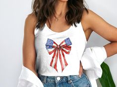 🇺🇸 Celebrate in style with this coquette Fourth of July patriotic tank top! Perfect for Memorial Day, featuring a USA flag bow design 🎉 Product Features: Fabrication: 60% combed ring-spun cotton, 40% polyester Seams: Side-seamed Fit: Slim Fit Sizing: Women's sizing / Runs smaller than usual Bow Tank Top, Bow Graphic, July Outfits, Graphic Tank Tops, 4th Of July Outfits, Womens Tops Summer, Bow Design, Design Product, Usa Flag