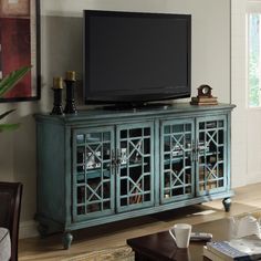 a living room scene with focus on the entertainment center and coffee table in the foreground