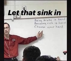 a man standing in front of a whiteboard with writing on it that says let that sink in