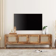 a flat screen tv mounted to the side of a wooden cabinet in a living room