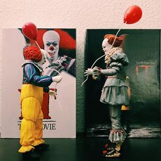 two clowns are standing next to each other with balloons in their hands and one is holding a red balloon