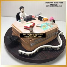 a cake that is shaped to look like a suitcase with a man sitting on it