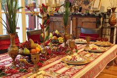 the table is set with fruit and flowers for an elegant holiday dinner or brunch