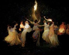 a group of women dressed in white dancing around a fire with their arms spread out