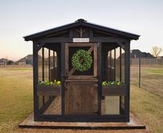 an outhouse with a wreath on the door