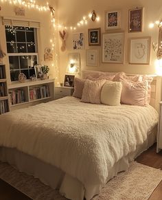 a white bed sitting in a bedroom next to a book shelf filled with lots of books