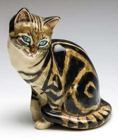 a cat figurine sitting on top of a table