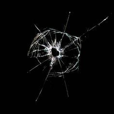 a broken glass window in the dark