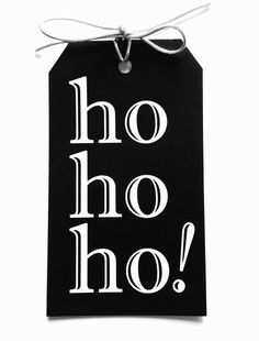 a black and white tag with the word hoo on it hanging from a string