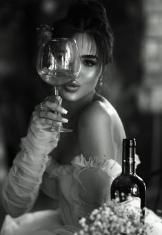 a woman holding a wine glass in front of her face