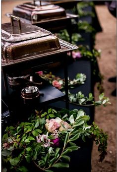 a row of planters filled with flowers on top of each other next to a stove