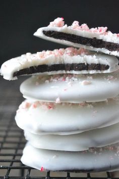 a stack of cookies with white frosting and sprinkles