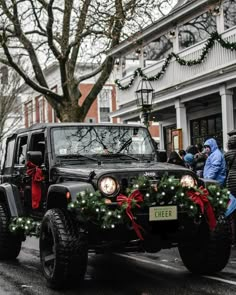 a jeep decorated for christmas driving down the street