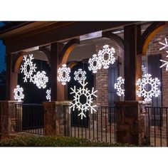 lighted snowflakes on the side of a house