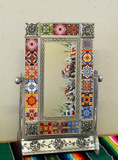 a colorful mirror sitting on top of a table