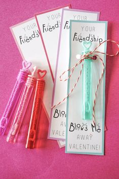 three valentine's day cards with twine and heart shaped straws tied to them