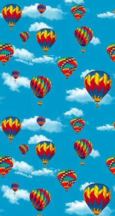 many colorful hot air balloons flying in the blue sky with white clouds on a sunny day