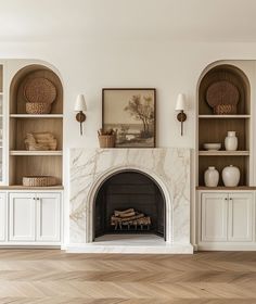 a living room filled with furniture and a fire place in front of a white fireplace