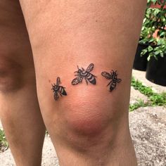 three bees tattoo on the thighs and legs, with one bee in the middle of the leg