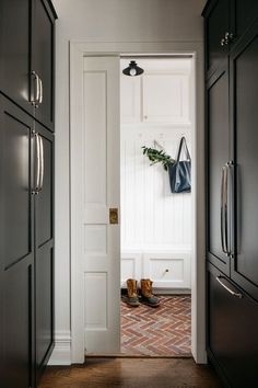 an open door leading to a hallway with shoes on the floor