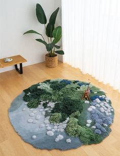 a living room with wood floors and a rug on the floor that has plants growing in it