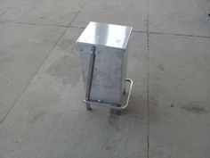 a metal box sitting on top of a sidewalk